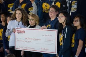 Beth Rohani with the IMD present Youngblood Intermediate with a check.